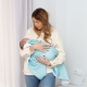 Manta polar mint. Mamá con un bebé en brazos tapado con una manta mint